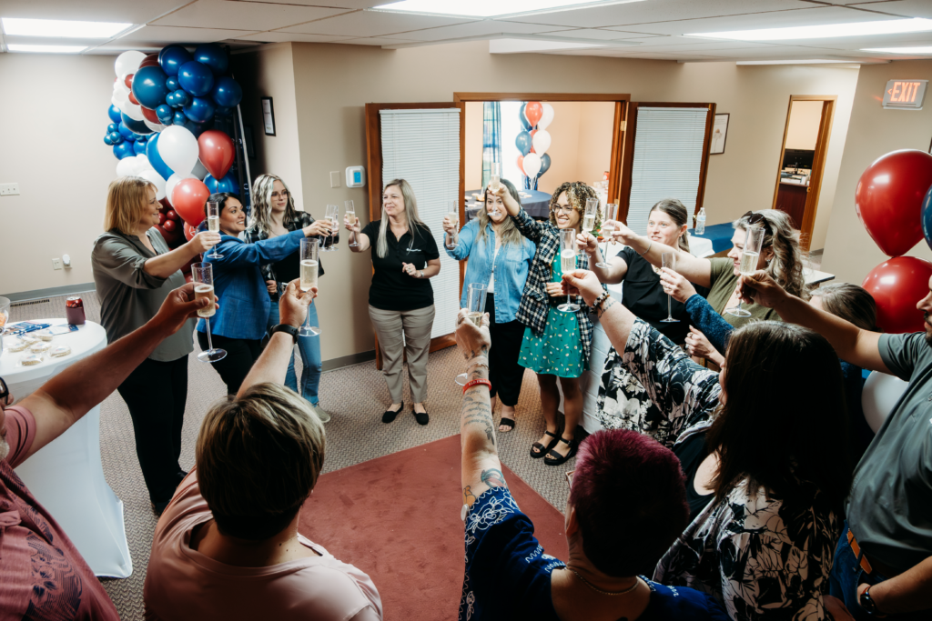The Springfield team shares a toast in the new office