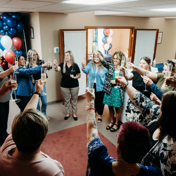 The Springfield team shares a toast in the new office